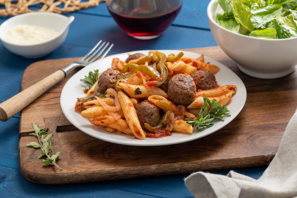 Penne pasta with Hungry Planet Italian sausage meatballs, sliced bell pepper, and tomato sauce